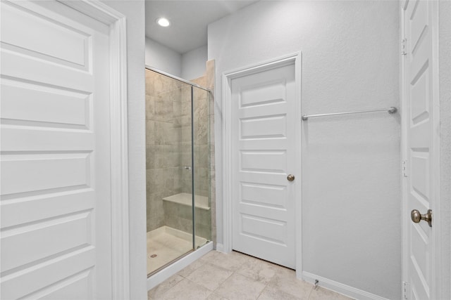 bathroom featuring tile patterned flooring and a shower with door