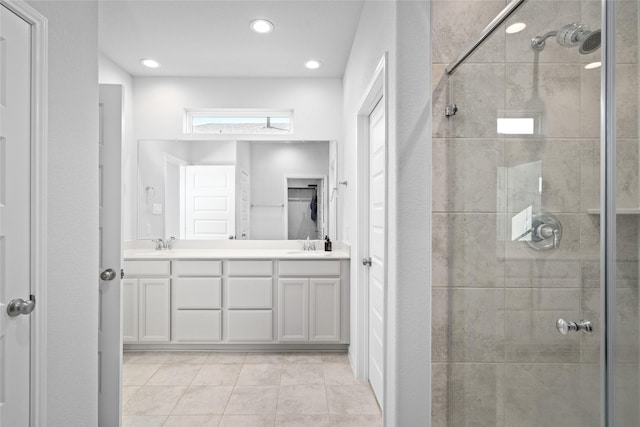 bathroom with tile patterned floors, a shower with door, and vanity