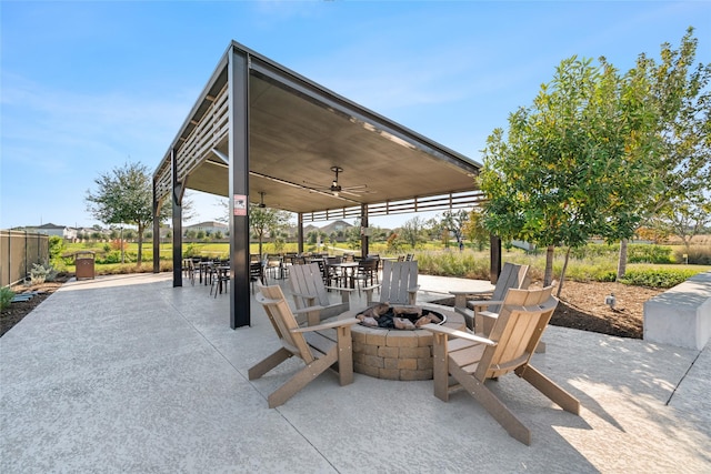 view of patio with ceiling fan and a fire pit