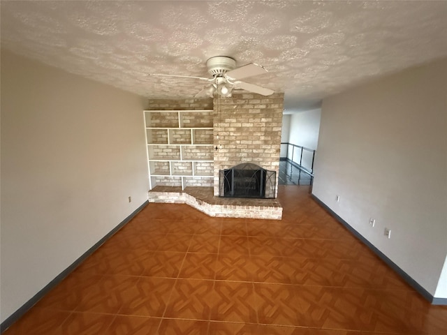 unfurnished living room with parquet flooring, a textured ceiling, a fireplace, and ceiling fan