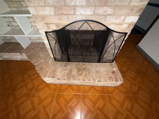 room details featuring parquet flooring and a brick fireplace