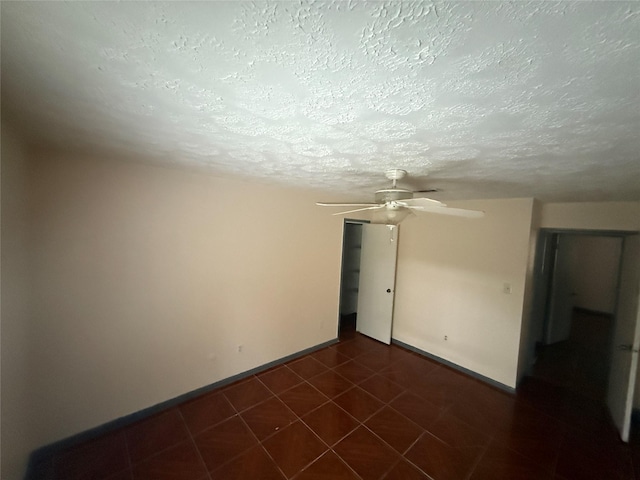 unfurnished room featuring a textured ceiling