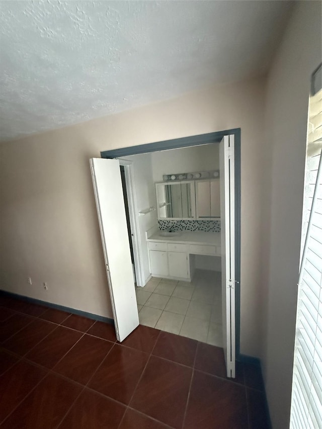 hall featuring dark tile patterned floors