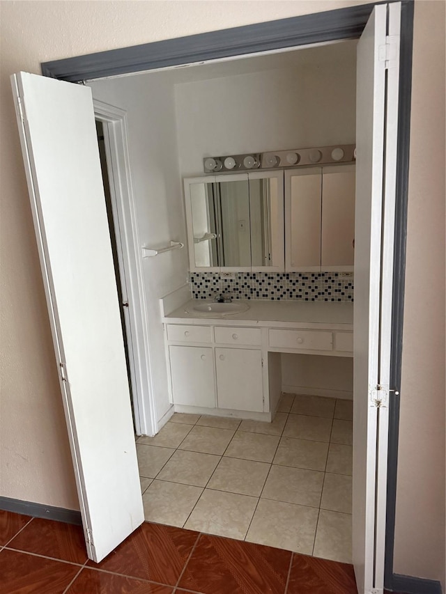 bathroom featuring tile patterned floors, decorative backsplash, and vanity