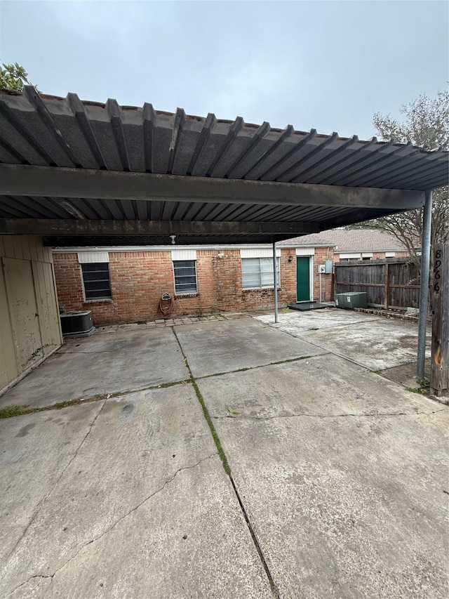 view of patio with central AC unit and a carport