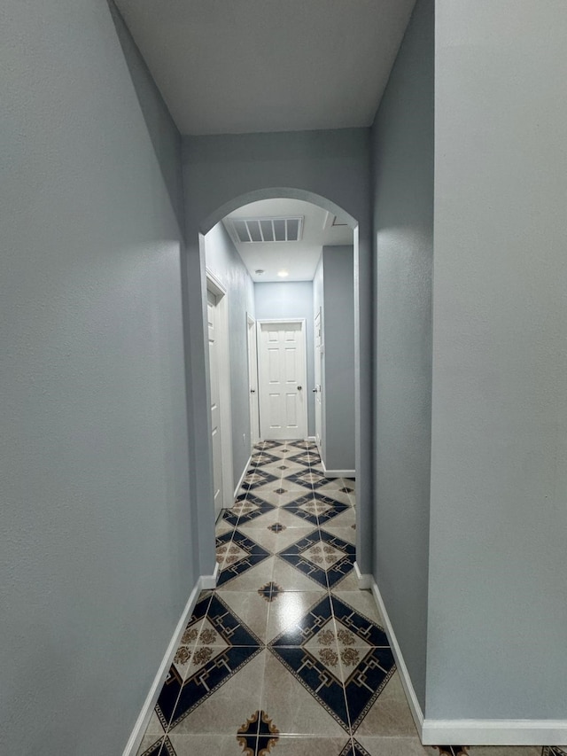 hallway featuring tile patterned flooring