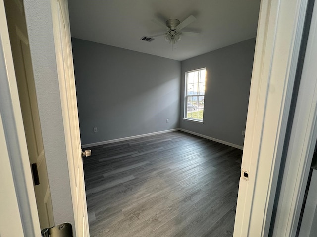 unfurnished room with ceiling fan and dark hardwood / wood-style floors