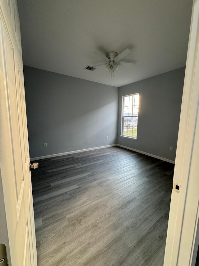 unfurnished bedroom with ceiling fan and dark hardwood / wood-style flooring