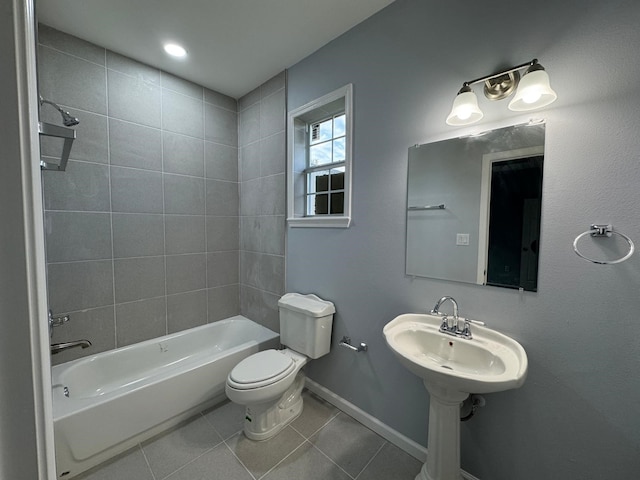 full bathroom with tile patterned flooring, sink, toilet, and tiled shower / bath