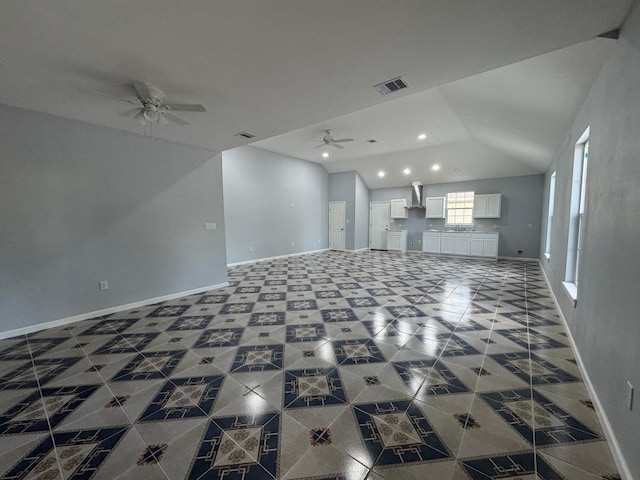 unfurnished living room featuring tile patterned flooring and ceiling fan