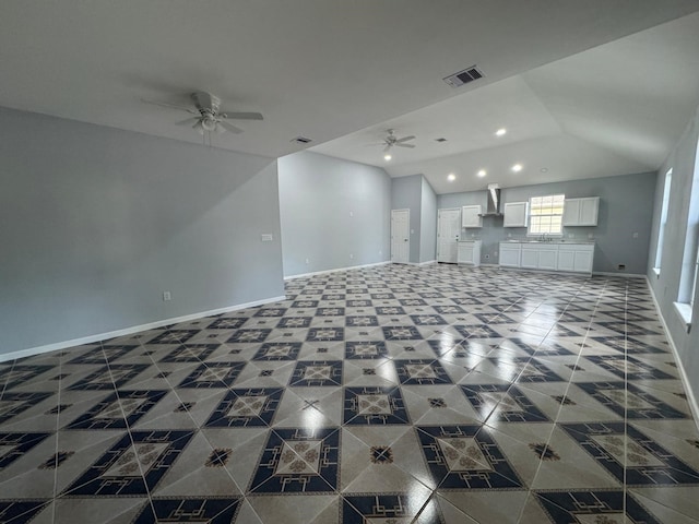 unfurnished living room featuring ceiling fan and sink