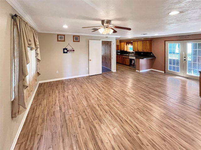 unfurnished living room featuring hardwood / wood-style floors, french doors, ornamental molding, and ceiling fan