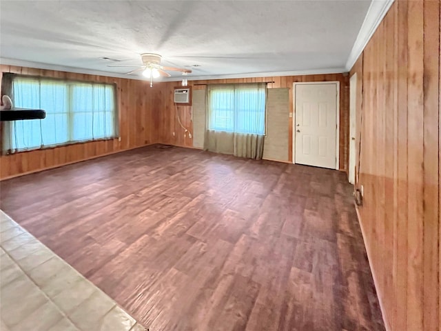 interior space featuring an AC wall unit, wooden walls, ceiling fan, and wood-type flooring