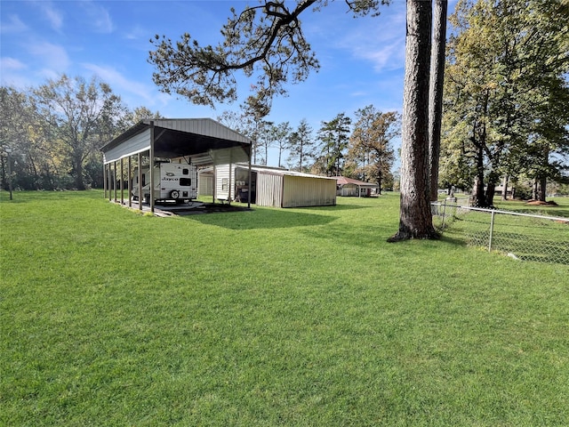 view of yard with an outbuilding and a carport