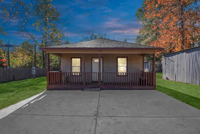 view of front of home with a yard and covered porch