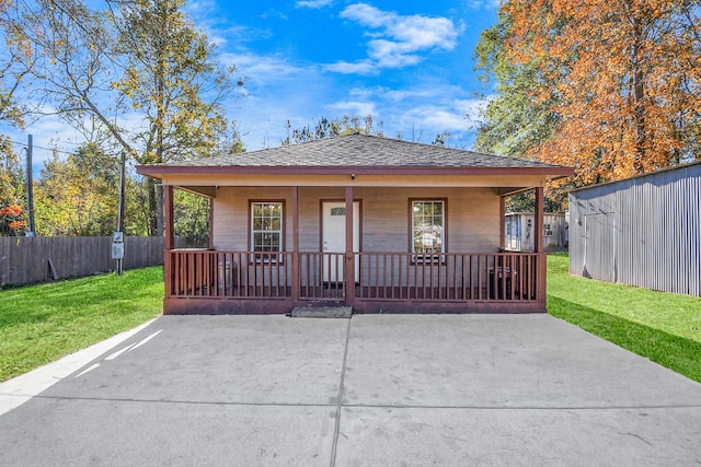 view of front of home featuring covered porch and a front yard