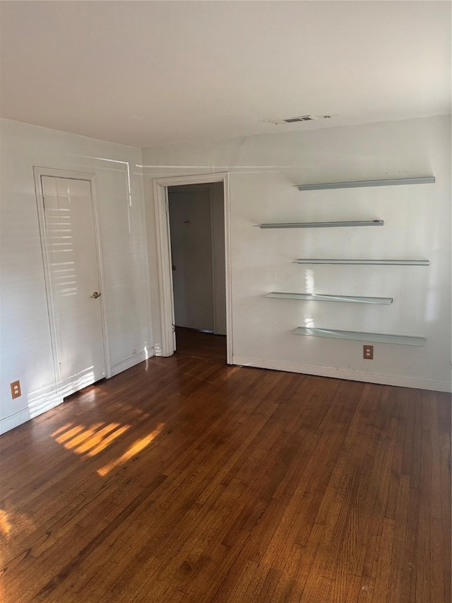 spare room featuring dark hardwood / wood-style floors