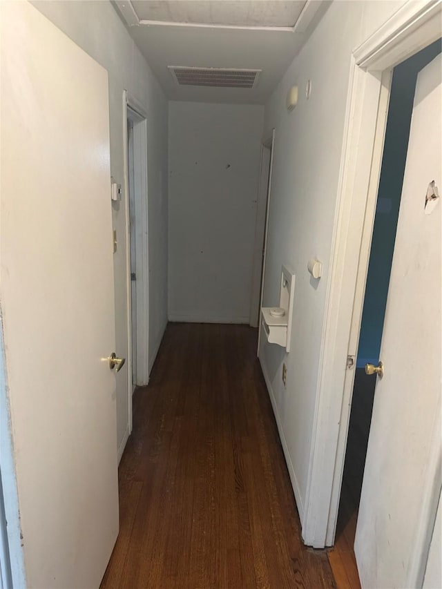 corridor with dark wood-type flooring