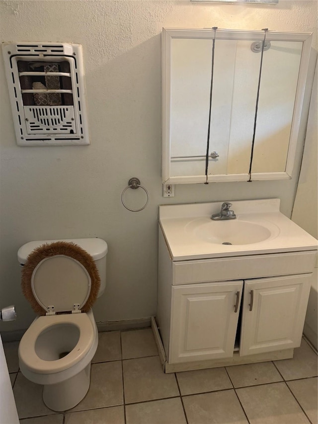 bathroom featuring tile patterned flooring, vanity, and toilet