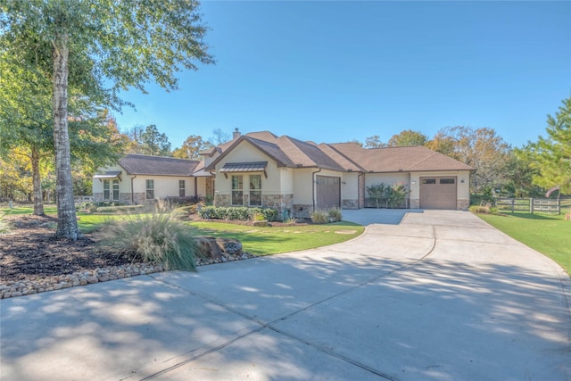 view of front of house featuring a garage and a front lawn