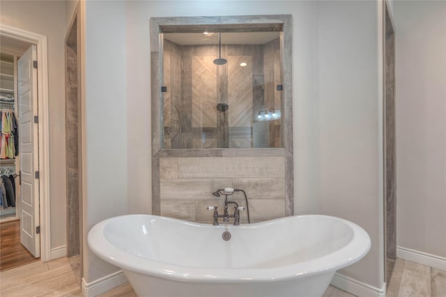 bathroom with separate shower and tub and hardwood / wood-style floors