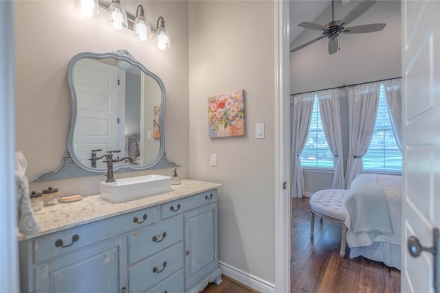 bathroom featuring ceiling fan, vanity, and wood-type flooring