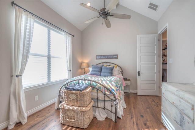 bedroom with ceiling fan, dark hardwood / wood-style flooring, and vaulted ceiling