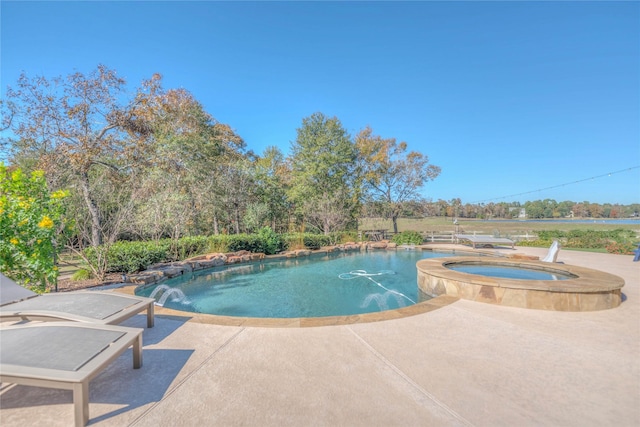 view of swimming pool featuring a patio area and an in ground hot tub