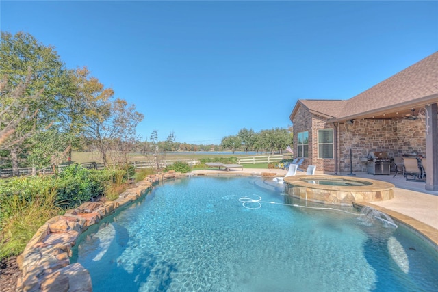 view of swimming pool featuring a patio area and an in ground hot tub