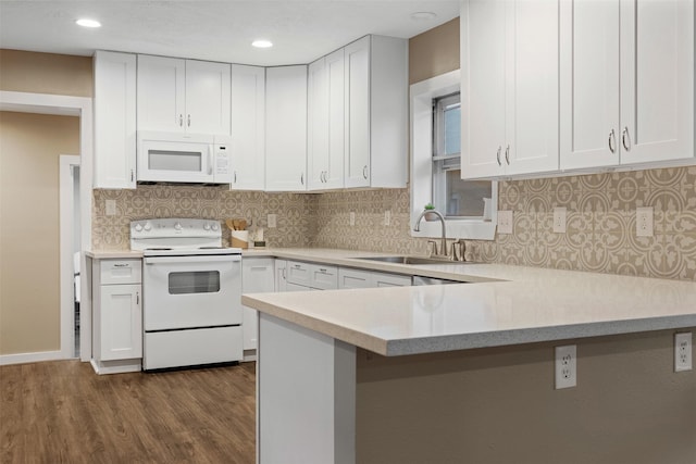 kitchen featuring dark hardwood / wood-style flooring, tasteful backsplash, white appliances, sink, and white cabinets