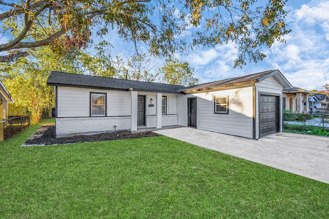 ranch-style house with a garage and a front lawn