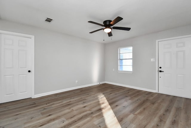 spare room with hardwood / wood-style floors and ceiling fan