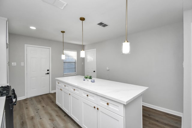 kitchen with a center island, white cabinets, decorative light fixtures, light stone counters, and wood-type flooring