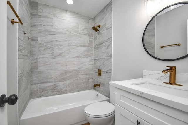 full bathroom featuring toilet, vanity, and tiled shower / bath combo