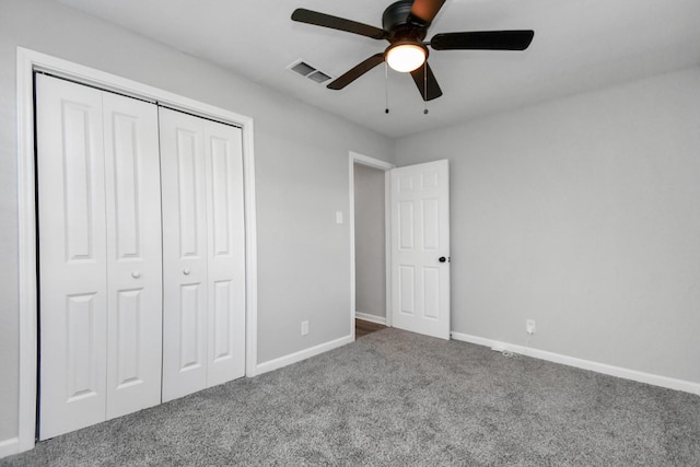 unfurnished bedroom featuring ceiling fan, a closet, and carpet floors