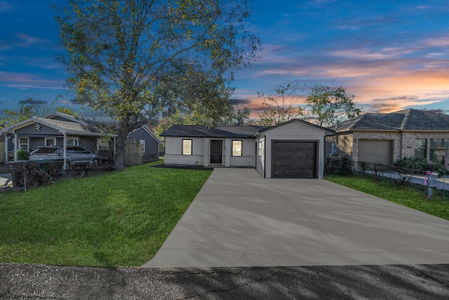 ranch-style house with a lawn and a garage