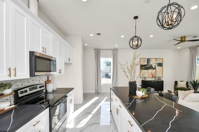 kitchen with pendant lighting, white cabinetry, stainless steel appliances, and tasteful backsplash