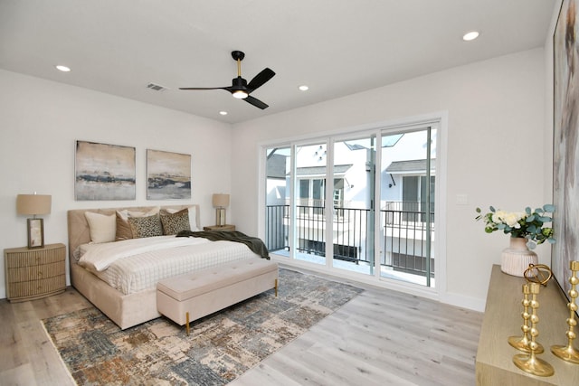 bedroom featuring access to outside, light hardwood / wood-style flooring, and ceiling fan