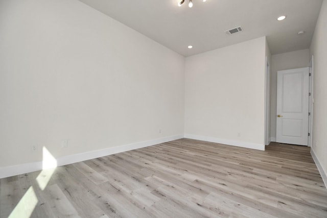 spare room featuring light hardwood / wood-style flooring