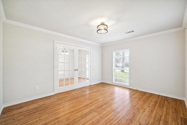 spare room with light hardwood / wood-style floors, crown molding, and french doors