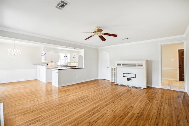 unfurnished living room featuring heating unit, crown molding, light hardwood / wood-style floors, and ceiling fan with notable chandelier