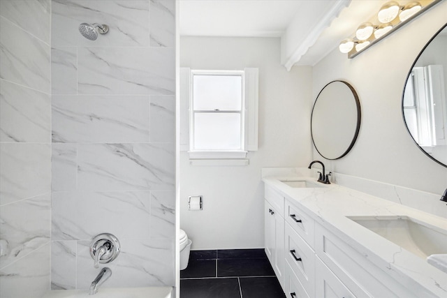 full bathroom with vanity, tiled shower / bath combo, toilet, and tile patterned flooring