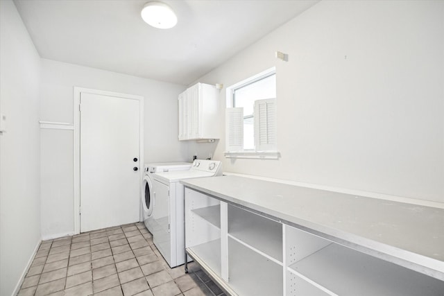 washroom with washer and dryer, light tile patterned flooring, and cabinets