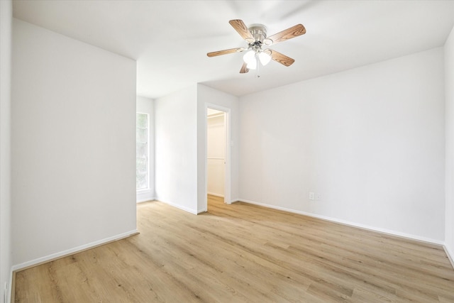 spare room featuring light hardwood / wood-style floors and ceiling fan