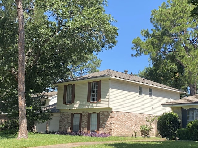 view of home's exterior with a lawn