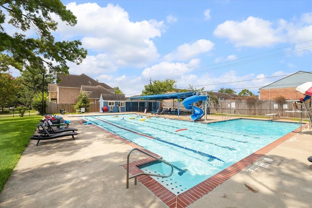 view of pool featuring a patio area and a water slide