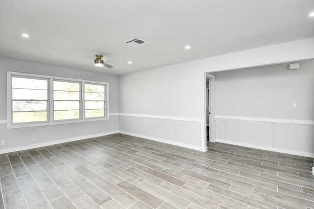 unfurnished room with ceiling fan and light wood-type flooring