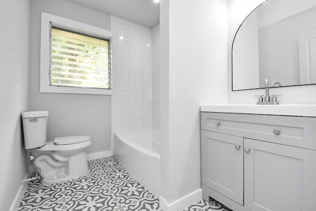 full bathroom with tile patterned flooring, vanity, tiled shower / bath combo, and toilet