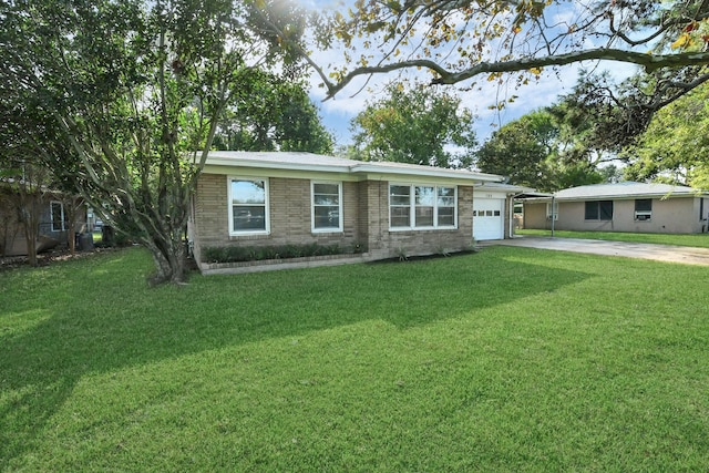 ranch-style house featuring a front yard, a garage, and a carport