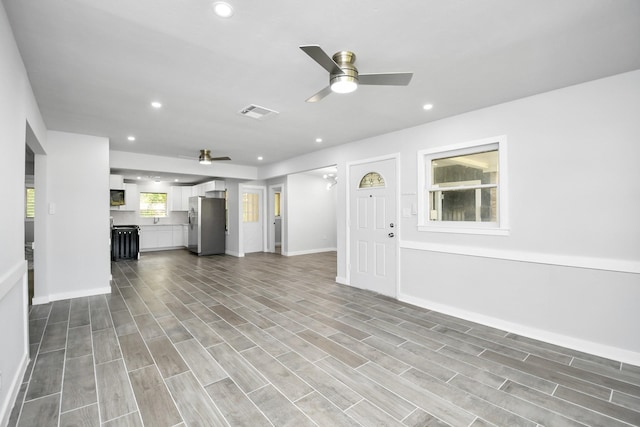 unfurnished living room featuring light hardwood / wood-style floors and ceiling fan